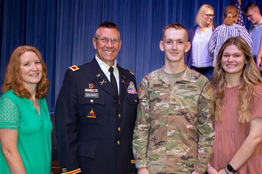 A student is honored for serving in the US Armed Forces after high school